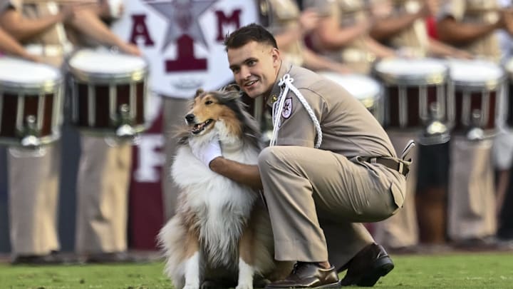 Oct 11, 2025; College Station, Texas, USA; Cadet Wilson Winchester takes a knee with Texas A&M Aggies mascot Reveille X prior to the game against the Florida Gators at Kyle Field. Mandatory Credit: Maria Lysaker-Imagn Images Oct 11, 2025; College Station, Texas, USA; Cadet Wilson Winchester takes a knee with Texas A&M Aggies mascot Reveille X prior to the game against the Florida Gators at Kyle Field. Mandatory Credit: Maria Lysaker-Imagn Images