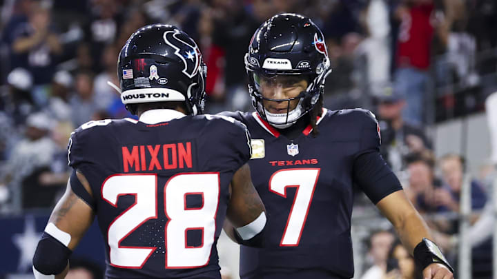 Nov 18, 2024; Arlington, Texas, USA;  Houston Texans running back Joe Mixon (28) celebrates with Houston Texans quarterback C.J. Stroud (7) after scoring a touchdown  during the first quarter against the Dallas Cowboys at AT&T Stadium. Mandatory Credit: Kevin Jairaj-Imagn Images