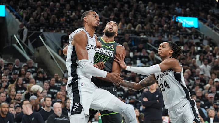 May 6, 2026; San Antonio, Texas, USA; San Antonio Spurs forward Victor Wembanyama (1) and guard Devin Vassell (24) block out Minnesota Timberwolves center Rudy Gobert (27) in the first half during game two of the second round of the 2026 NBA Playoffs at Frost Bank Center. Mandatory Credit: Daniel Dunn-Imagn Images