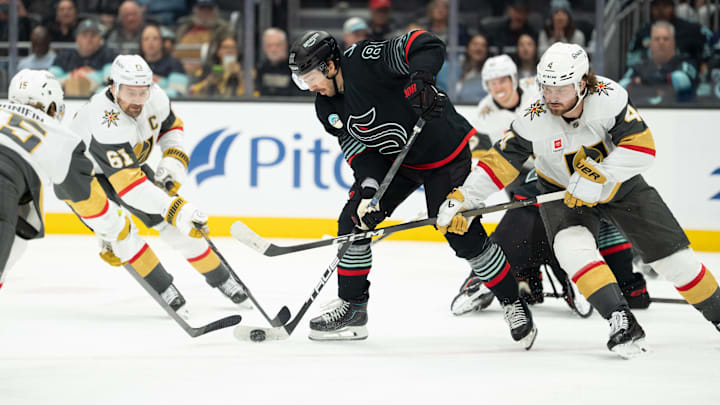 Apr 9, 2026; Seattle, Washington, USA; Seattle Kraken forward Frederick Gaudreau (89) battles Vegas Golden Knights defenseman Noah Hanifin (15), left, forward Mark Stone (61) and defenseman Rasmus Andersson (4) for the puck during the second period at Climate Pledge Arena. Mandatory Credit: Stephen Brashear-Imagn Images Apr 9, 2026; Seattle, Washington, USA; Seattle Kraken forward Frederick Gaudreau (89) battles Vegas Golden Knights defenseman Noah Hanifin (15), left, forward Mark Stone (61) and defenseman Rasmus Andersson (4) for the puck during the second period at Climate Pledge Arena. Mandatory Credit: Stephen Brashear-Imagn Images