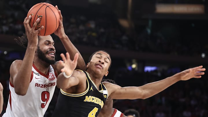 Arkansas Razorbacks forward Jonas Aidoo (9) and Michigan Wolverines guard Nimari Burnett (4) fight for a loose ball in the first half at Madison Square Garden.
