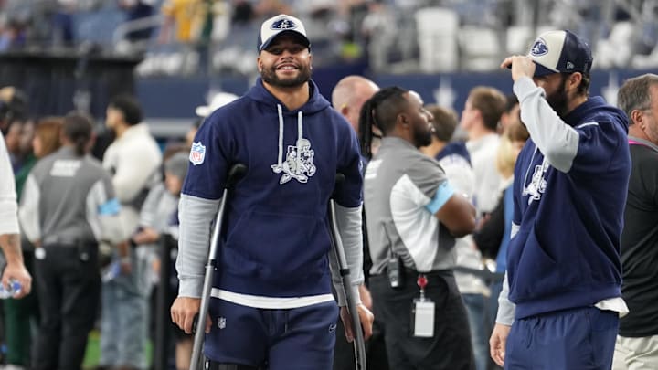 Nov 28, 2024; Arlington, Texas, USA;  Dallas Cowboys quarterback Dak Prescott (left) stands on crutches before the game against the New York Giants at AT&T Stadium. Mandatory Credit: Chris Jones-Imagn Images