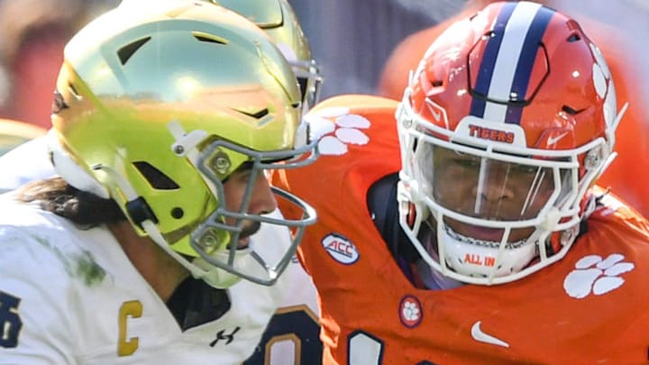 Notre Dame quarterback Sam Hartman (10) runs by Clemson defensive lineman Peter Woods (11) for a touchdown 