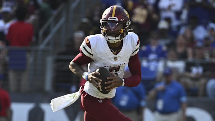 Oct 13, 2024; Baltimore, Maryland, USA;  Washington Commanders quarterback Jayden Daniels (5) rolls out to pass during the second half against the Baltimore Ravens at M&T Bank Stadium. Mandatory Credit: Tommy Gilligan-Imagn Images