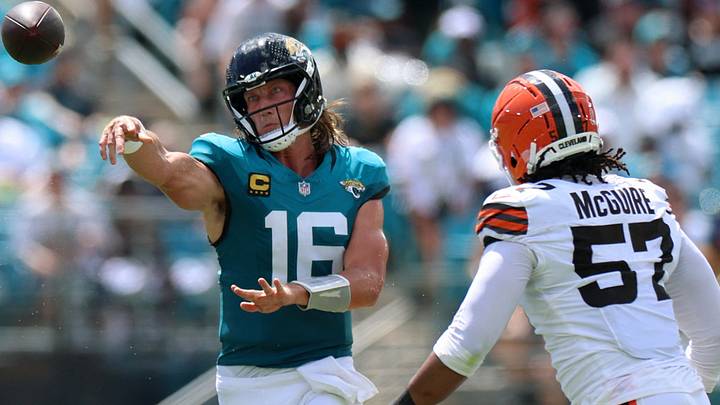 Sep 13, 2026; Jacksonville, Florida, USA;  Jacksonville Jaguars quarterback Trevor Lawrence (16) attempts a pass to tight end Quintin Morris (80) under pressure from Cleveland Browns defensive end Isaiah McGuire (57) in the second quarter at EverBank Stadium.  Mandatory Credit: Nathan Ray Seebeck-Imagn Images