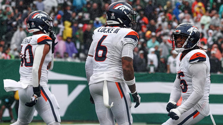 Sep 29, 2024; East Rutherford, New Jersey, USA; Denver Broncos safety P.J. Locke (6) celebrates a fourth quarter, fourth down defensive stop with linebacker Justin Strnad (40) and linebacker Nik Bonitto (15) during the second half against the New York Jets at MetLife Stadium. 