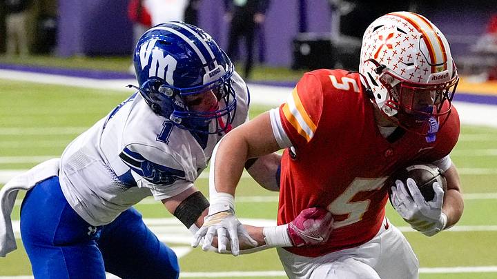 Kuemper Catholic’s Jarin Hoffman (5) carries the ball as Van Meter’s Andon Watson (1) looks to make a tackle Nov. 21, 2025 during the Class 2A high school state football championship at the UNI-Dome in Cedar Falls, Iowa. Kuemper Catholic’s Jarin Hoffman (5) carries the ball as Van Meter’s Andon Watson (1) looks to make a tackle Nov. 21, 2025 during the Class 2A high school state football championship at the UNI-Dome in Cedar Falls, Iowa.