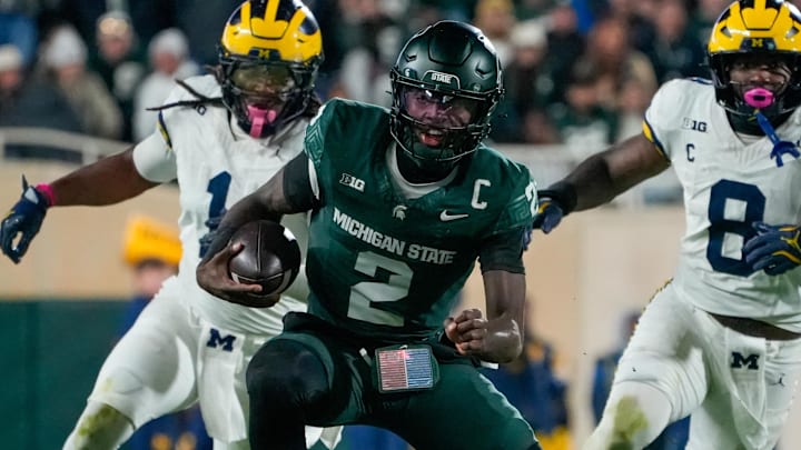 Oct 25, 2025; East Lansing, Michigan, USA; Michigan State Spartans quarterback Aidan Chiles (2) carries the ball against the Michigan Wolverines during the second half at Spartan Stadium.