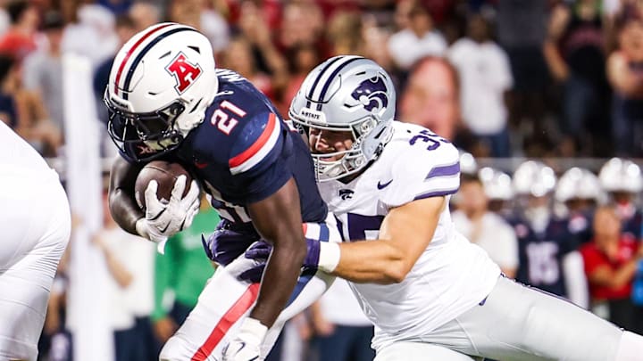 Sep 12, 2025; Tucson, Arizona, USA; Kansas State Wildcats linebacker Gabe Powers (35) tackles Arizona Wildcats running back Ismail Mahdi (21) during the second quarter of the game at Arizona Stadium. Mandatory Credit: Aryanna Frank-Imagn Images Sep 12, 2025; Tucson, Arizona, USA; Kansas State Wildcats linebacker Gabe Powers (35) tackles Arizona Wildcats running back Ismail Mahdi (21) during the second quarter of the game at Arizona Stadium. Mandatory Credit: Aryanna Frank-Imagn Images
