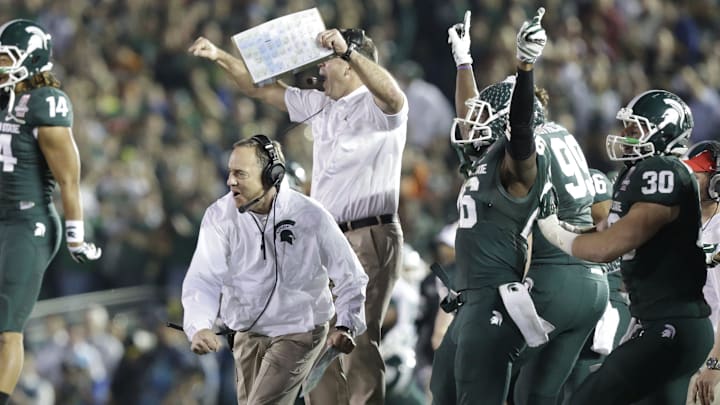 Michigan State coach Mark Dantonio and players celebrate after their defense gets a big stop to force a turnover, effectively sealing the win, against Stanford at the Rose Bowl in Pasadena, Cali. on Wednesday, Jan. 1, 2014.

010114 Rosebowl Jh 15