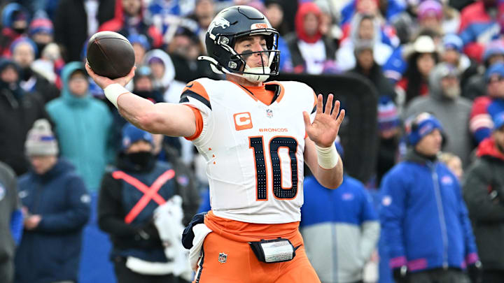 Jan 12, 2025; Orchard Park, New York, USA; Denver Broncos quarterback Bo Nix (10) throws downfield during the fourth quarter against the Buffalo Bills in an AFC wild card game at Highmark Stadium. 