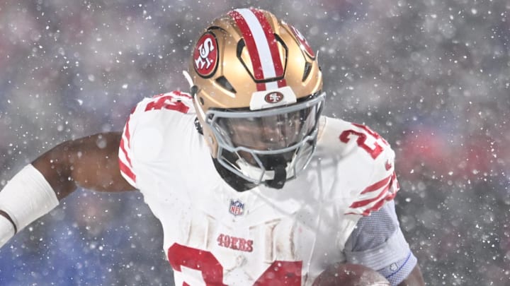 Dec 1, 2024; Orchard Park, New York, USA; San Francisco 49ers running back Jordan Mason (24) runs with the ball in the third quarter against the Buffalo Bills at Highmark Stadium. Mandatory Credit: Mark Konezny-Imagn Images