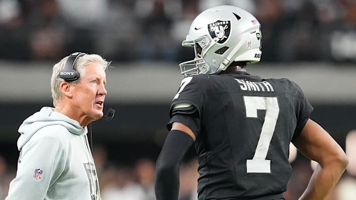 Nov 23, 2025; Paradise, Nevada, USA; Las Vegas Raiders quarterback Geno Smith (7) talks to head coach Pete Carroll in game against the Cleveland Browns during the fourth quarter at Allegiant Stadium. Mandatory Credit: Stephen R. Sylvanie-Imagn Images
