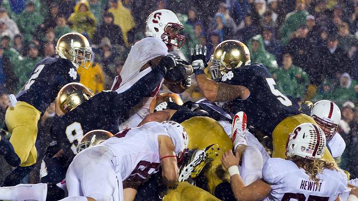 Oct. 13, 2012; South Bend, IN, USA; Stanford Cardinal running back Stepfan Taylor (33) attempts to dive over the goal line as Notre Dame Fighting Irish nose guard Louis Nix (9) and linebacker Manti Te'o (5) defend in overtime at Notre Dame Stadium. Notre Dame won 20-13. Oct. 13, 2012; South Bend, IN, USA; Stanford Cardinal running back Stepfan Taylor (33) attempts to dive over the goal line as Notre Dame Fighting Irish nose guard Louis Nix (9) and linebacker Manti Te'o (5) defend in overtime at Notre Dame Stadium. Notre Dame won 20-13.