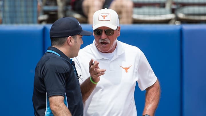 Texas Longhorns head coach Mike White talks to home plate umpire in the fourth inning against the Tennessee Lady Volunteers. Texas Longhorns head coach Mike White talks to home plate umpire in the fourth inning against the Tennessee Lady Volunteers.