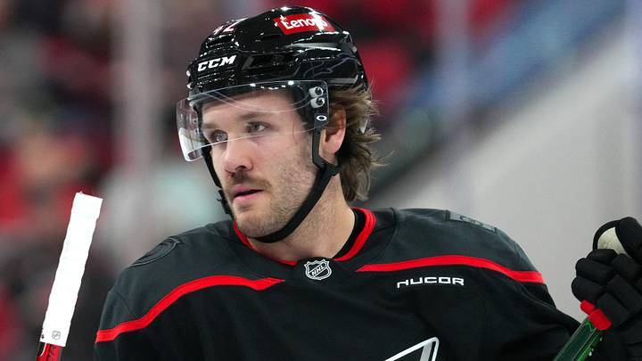 Jan 4, 2025; Raleigh, North Carolina, USA;  Carolina Hurricanes defenseman Ty Smith (42) looks on against the Minnesota Wild during the first period at Lenovo Center. Mandatory Credit: James Guillory-Imagn Images