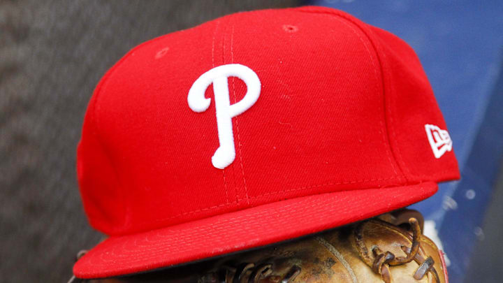 A detailed view of Philadelphia Phillies hat and glove in the dugout