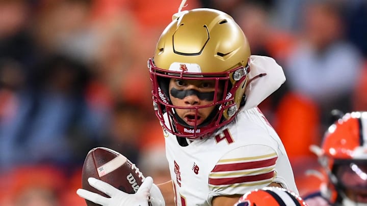Nov 29, 2025; Syracuse, New York, USA; Boston College Eagles wide receiver Reed Harris (4) runs with the ball after a catch in front of Syracuse Orange defensive back Braheem Long Jr. (0) during the first half at the JMA Wireless Dome. Mandatory Credit: Rich Barnes-Imagn Images