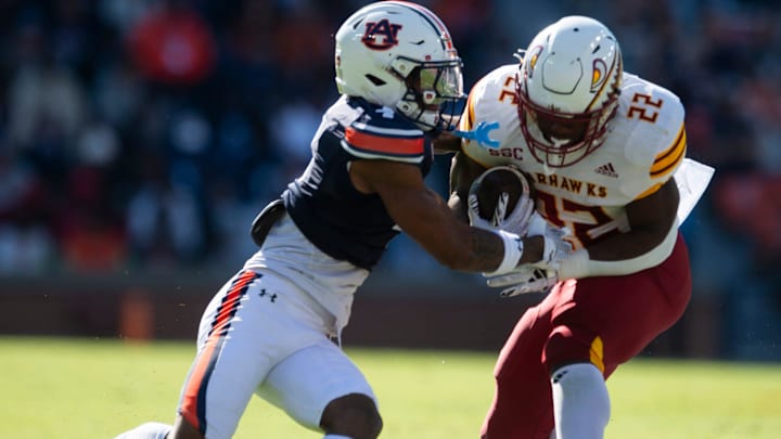 Louisiana-Monroe Warhawks running back Ahmad Hardy (22) breaks a tackle attempt from Auburn Tigers defensive back Kayin Lee (4) as Auburn Tigers take on Louisiana-Monroe Warhawks at Jordan-Hare Stadium in Auburn, Ala., on Saturday, Nov. 16, 2024. Auburn Tigers lead Louisiana-Monroe Warhawks 24-0 at halftime.
