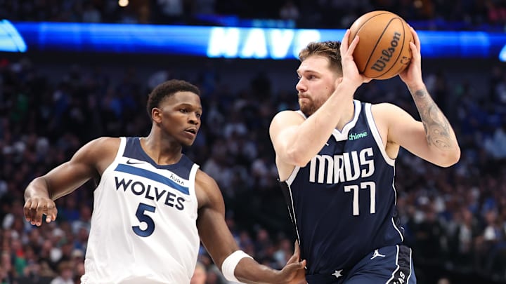 May 28, 2024; Dallas, Texas, USA; Dallas Mavericks guard Luka Doncic (77) dribbles against Minnesota Timberwolves guard Anthony Edwards (5) during the third quarter of game four of the western conference finals for the 2024 NBA playoffs at American Airlines Center. Mandatory Credit: Kevin Jairaj-Imagn Images