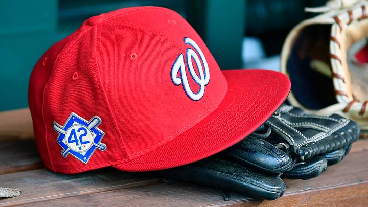 Red Washington Nationals hat on top of a black mitt Red Washington Nationals hat on top of a black mitt