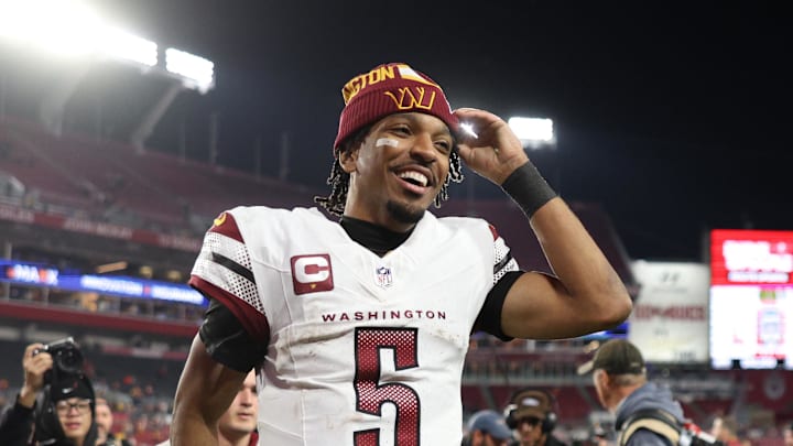 Jan 12, 2025; Tampa, Florida, USA; Washington Commanders quarterback Jayden Daniels (5) celebrates after winning a NFC wild card playoff against the Tampa Bay Buccaneers at Raymond James Stadium. Mandatory Credit: Nathan Ray Seebeck-Imagn Images