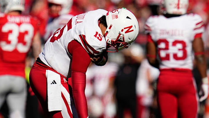 Nebraska quarterback Dylan Raiola favors his shoulder after being hit while making a throw against Ohio State last season.