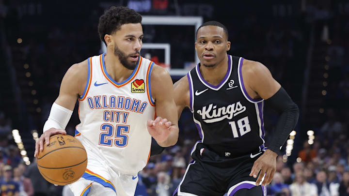 Oct 28, 2025; Oklahoma City, Oklahoma, USA; Oklahoma City Thunder guard Ajay Mitchell (25) drives past Sacramento Kings guard Russell Westbrook (18) during the second half at Paycom Center. Mandatory Credit: Alonzo Adams-Imagn Images