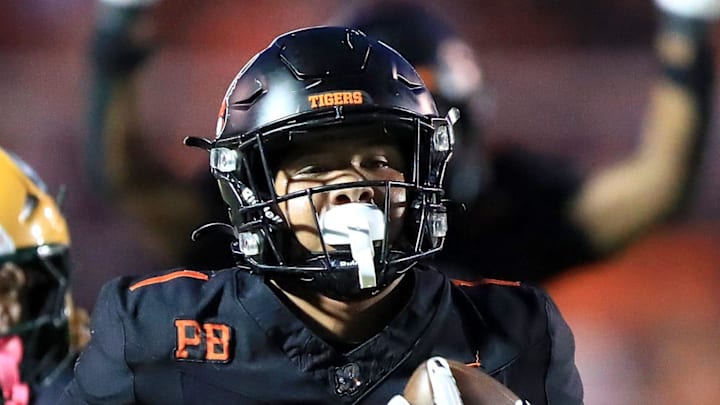Massillon running back Savior Owens races for a touchdown as St. Edward's Makhl Boone gives chase during action Friday night, September 19, 2025 at Paul Brown Tiger Stadium. Ed Hall Jr. / Special To The Repository