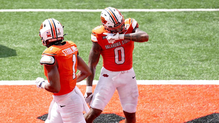 Oklahoma State's Ollie Gordon II (0) celebrates a touchdown next to De'Zhaun Stribling (1) in the second half of the college football game between the Oklahoma State Cowboys and South Dakota State Jackrabbits at Boone Pickens Stadium in Stillwater, Okla., Saturday, Aug., 31, 2024. Oklahoma State's Ollie Gordon II (0) celebrates a touchdown next to De'Zhaun Stribling (1) in the second half of the college football game between the Oklahoma State Cowboys and South Dakota State Jackrabbits at Boone Pickens Stadium in Stillwater, Okla., Saturday, Aug., 31, 2024.
