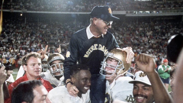 Jan 1, 1990; Miami, FL, USA; FILE PHOTO; Notre Dame Irish head coach Lou Holtz is carried off the field following their victory over Colorado winning the 1989 National Championship at the Orange Bowl. Mandatory Credit: Photo By Imagn Images © Copyright  Imagn Images