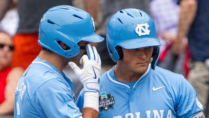 Jun 20, 2026; Omaha, NE, USA; North Carolina Tar Heels second baseman Gavin Gallaher (5) talks with designated hitter MacOn Winslow (6) after scoring on a sacrifice fly against the Oklahoma Sooners during the first inning at Charles Schwab Field. Mandatory Credit: Dylan Widger-Imagn Images