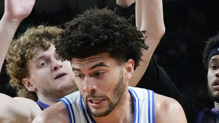 Duke Blue Devils forward Cameron Boozer (12) spins to score near TCU Horned Frogs forward David Punch (15) March 21, 2026 during the second half of the NCAA Men’s Basketball Tournament second round East Region game at the Bon Secours Wellness Arena in Greenville, South Carolina.