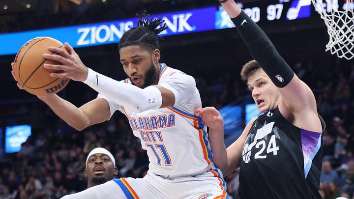 Feb 21, 2025; Salt Lake City, Utah, USA; Oklahoma City Thunder guard Isaiah Joe (11) rebounds against Utah Jazz center Walker Kessler (24) during the fourth quarter at Delta Center. Mandatory Credit: Rob Gray-Imagn Images