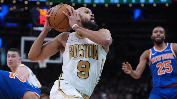 Feb 8, 2026; Boston, Massachusetts, USA; Boston Celtics guard Derrick White (9) drives the ball past New York Knicks center Karl-Anthony Towns (32) in the second half at TD Garden. Mandatory Credit: David Butler II-Imagn Images