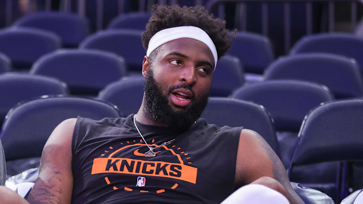 Nov 9, 2025; New York, New York, USA;  New York Knicks center Mitchell Robinson (23) sits courtside during pregame warmups prior to the game against the Brooklyn Nets at Madison Square Garden. Mandatory Credit: Wendell Cruz-Imagn Images