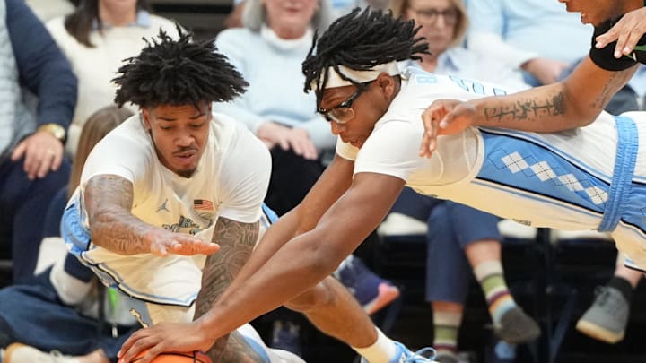 Dec 13, 2025; Chapel Hill, North Carolina, USA; North Carolina Tar Heels guard Derek Dixon (3) and forward James Brown (2) and USC Upstate Spartans forward Jafeth Martinez (12) dive for the ball in the second half at Dean E. Smith Center. Mandatory Credit: Bob Donnan-Imagn Images Dec 13, 2025; Chapel Hill, North Carolina, USA; North Carolina Tar Heels guard Derek Dixon (3) and forward James Brown (2) and USC Upstate Spartans forward Jafeth Martinez (12) dive for the ball in the second half at Dean E. Smith Center. Mandatory Credit: Bob Donnan-Imagn Images