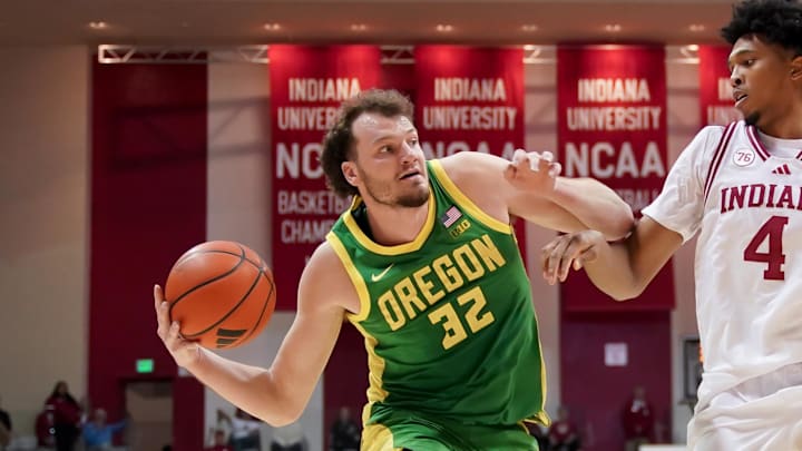 Feb 9, 2026; Bloomington, Indiana, USA; Oregon Ducks center Nate Bittle (32) dribbles against Indiana Hoosiers forward Sam Alexis (4) during the second half at Simon Skjodt Assembly Hall. Mandatory Credit: Robert Goddin-Imagn Images 