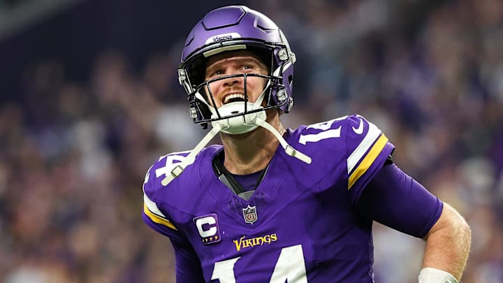 Dec 8, 2024; Minneapolis, Minnesota, USA; Minnesota Vikings quarterback Sam Darnold (14) celebrates running back Aaron Jones' (33) touchdown run against the Atlanta Falcons during the fourth quarter at U.S. Bank Stadium. Mandatory Credit: Matt Krohn-Imagn Images