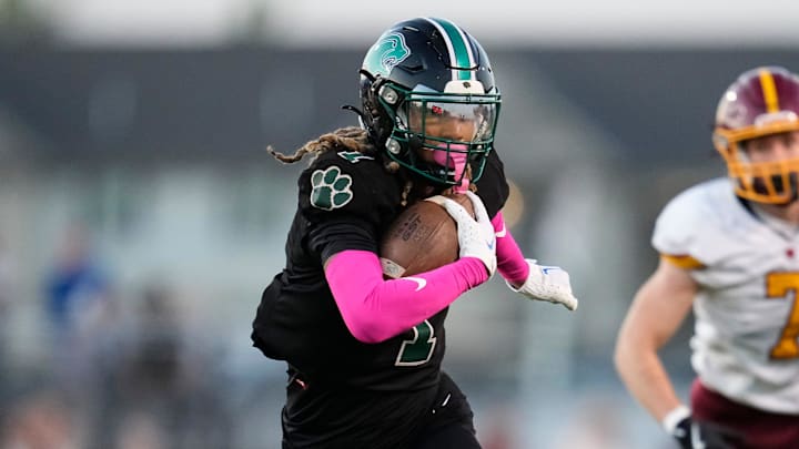 Oct 4, 2024; Galloway, Ohio, USA; Westland ATH Emoni Smith (1) rushes upfield past Westerville North DB Trey McDonald (7) during the first half of the OHSAA football game at Westland High School.