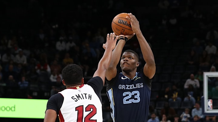 Oct 24, 2025; Memphis, Tennessee, USA; Grizzlies forward Cedric Coward (23) shooting over Heat guard Dru Smith (12) in the Grizzlies' regular season loss against the Miami Heat.