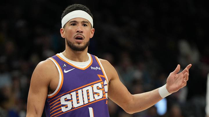 Phoenix Suns guard Devin Booker reacts after a foul call against the Philadelphia 76ers during the second half of an NBA game at Mortgage Matchup Center.