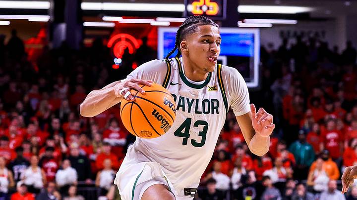 Jan 28, 2026; Cincinnati, Ohio, USA; Baylor Bears guard Cameron Carr (43) dribbles against Cincinnati Bearcats guard Jizzle James (2) in the second half at Fifth Third Arena. Mandatory Credit: Katie Stratman-Imagn Images
