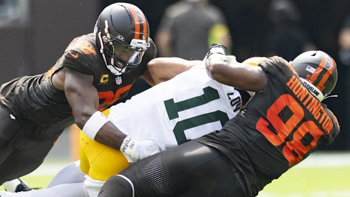 Cleveland Browns defensive ends Myles Garrett (95) and Adin Huntington (98) sack Green Bay Packers quarterback Jordan Love. Cleveland Browns defensive ends Myles Garrett (95) and Adin Huntington (98) sack Green Bay Packers quarterback Jordan Love.