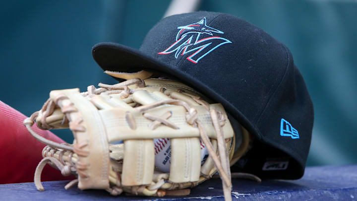 Apr 24, 2024; Atlanta, Georgia, USA; A detailed view of a Miami Marlins hat and glove in the dugout before a game against the Atlanta Braves at Truist Park. Mandatory Credit: Brett Davis-Imagn Images