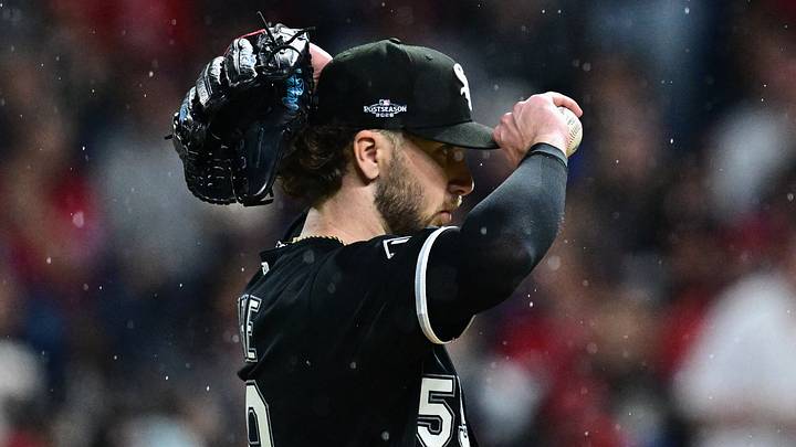 Oct 10, 2026; Cleveland, Ohio, USA;  Chicago White Sox pitcher Sean Burke (59) adjusts his cap in the rain during the second inning against the Cleveland Guardians in game five of the ALDS for the 2026 MLB Playoffs at Progressive Field.  Mandatory Credit: David Dermer-Imagn Images