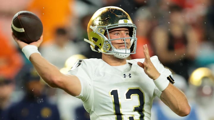 Aug 31, 2025; Miami Gardens, Florida, USA; Notre Dame Fighting Irish quarterback CJ Carr (13) drops back to pass against the Miami Hurricanes during the first quarter at Hard Rock Stadium.