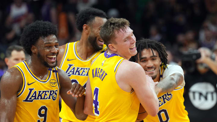 Oct 17, 2024; Phoenix, Arizona, USA; Los Angeles Lakers guard Bronny James (9) and Los Angeles Lakers guard Dalton Knecht (4) and Los Angeles Lakers guard Jalen Hood-Schifino (0) celebrate after defeating the Phoenix Suns at Footprint Center. Mandatory Credit: Joe Camporeale-Imagn Images