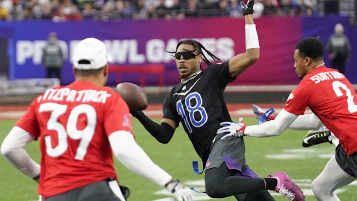 Feb 5, 2023; Paradise, Nevada, USA; NFC wide receiver Justin Jefferson of the Minnesota Vikings (18) runs the ball against AFC cornerback Pat Surtain II of the Denver Broncos (2) and right safety Jamal Agnew of the Jacksonville Jaguars (39) during game three of the 2023 Pro Bowl at Allegiant Stadium.