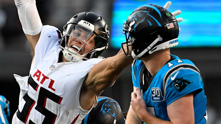 Oct 13, 2024; Charlotte, North Carolina, USA; Carolina Panthers quarterback Andy Dalton (14) passes the ball as Atlanta Falcons linebacker Kaden Elliss (55) pressures in the second quarter at Bank of America Stadium. Mandatory Credit: Bob Donnan-Imagn Images